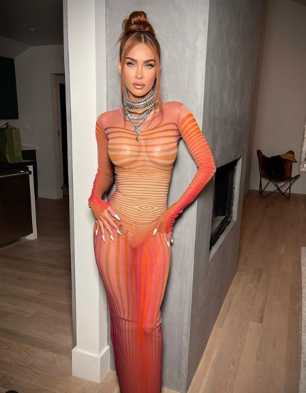 Fox on red carpet wearing her see through orange dress