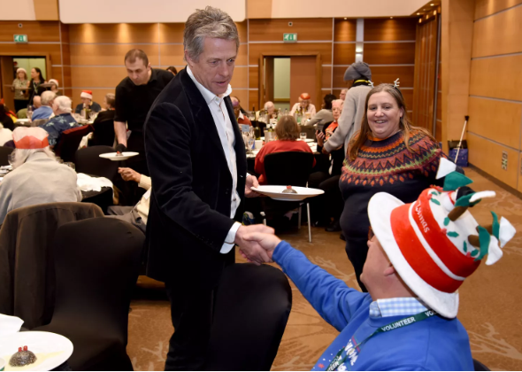 Hugh Grant Spreads Christmas Cheer by Serving Meals to 500 Elderly Residents in London: A Real-Life Love Actually Moment