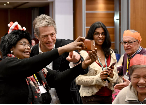 Grant taking a selfie with  residents 