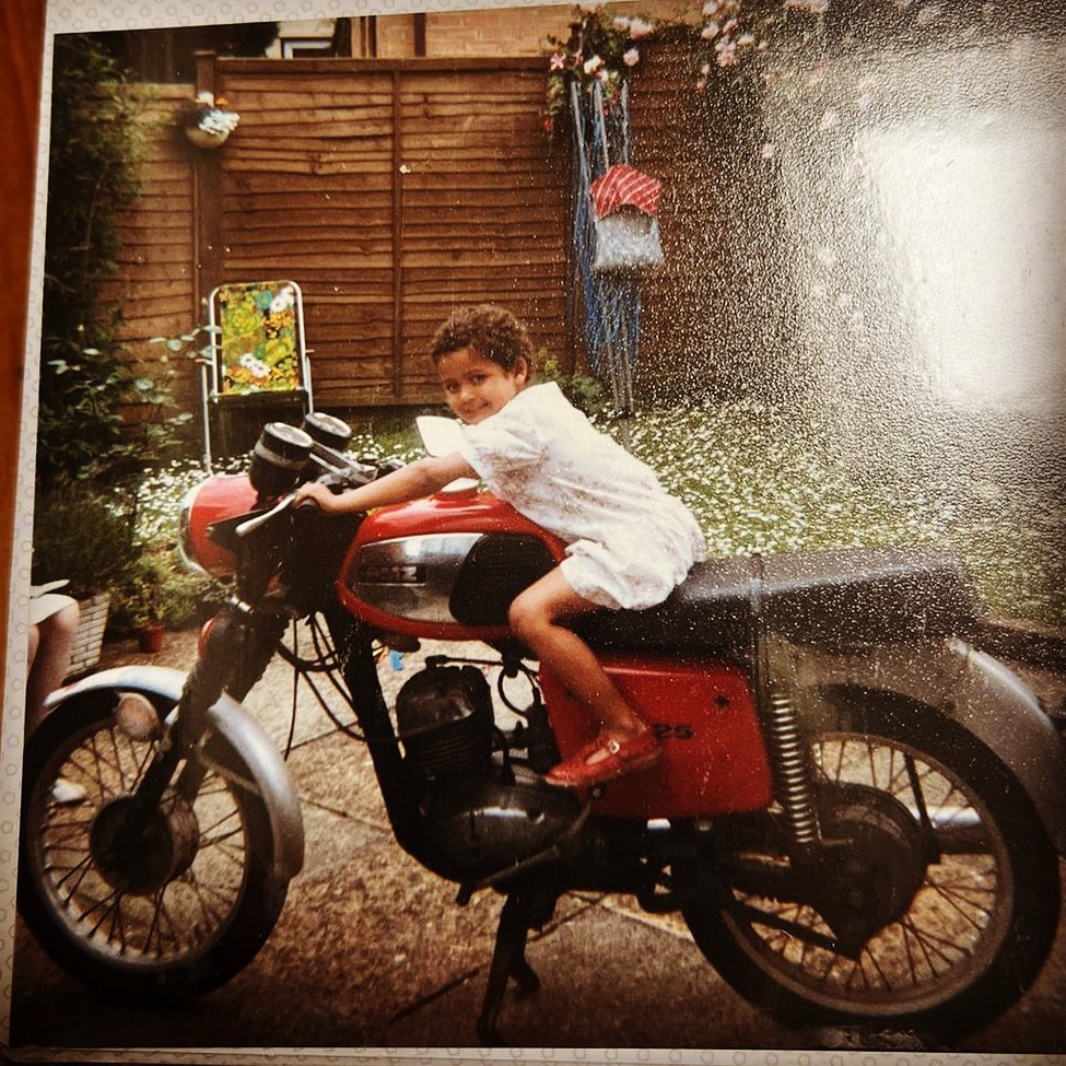 Young Gugu Mbatha Raw pausing for a photo on a bike