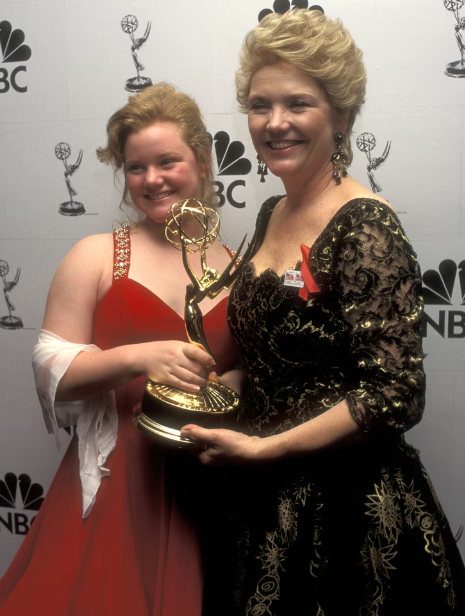 Amanda Daveis, on the left hand, held on to mom's trophy during a photo opp at the ceremony.