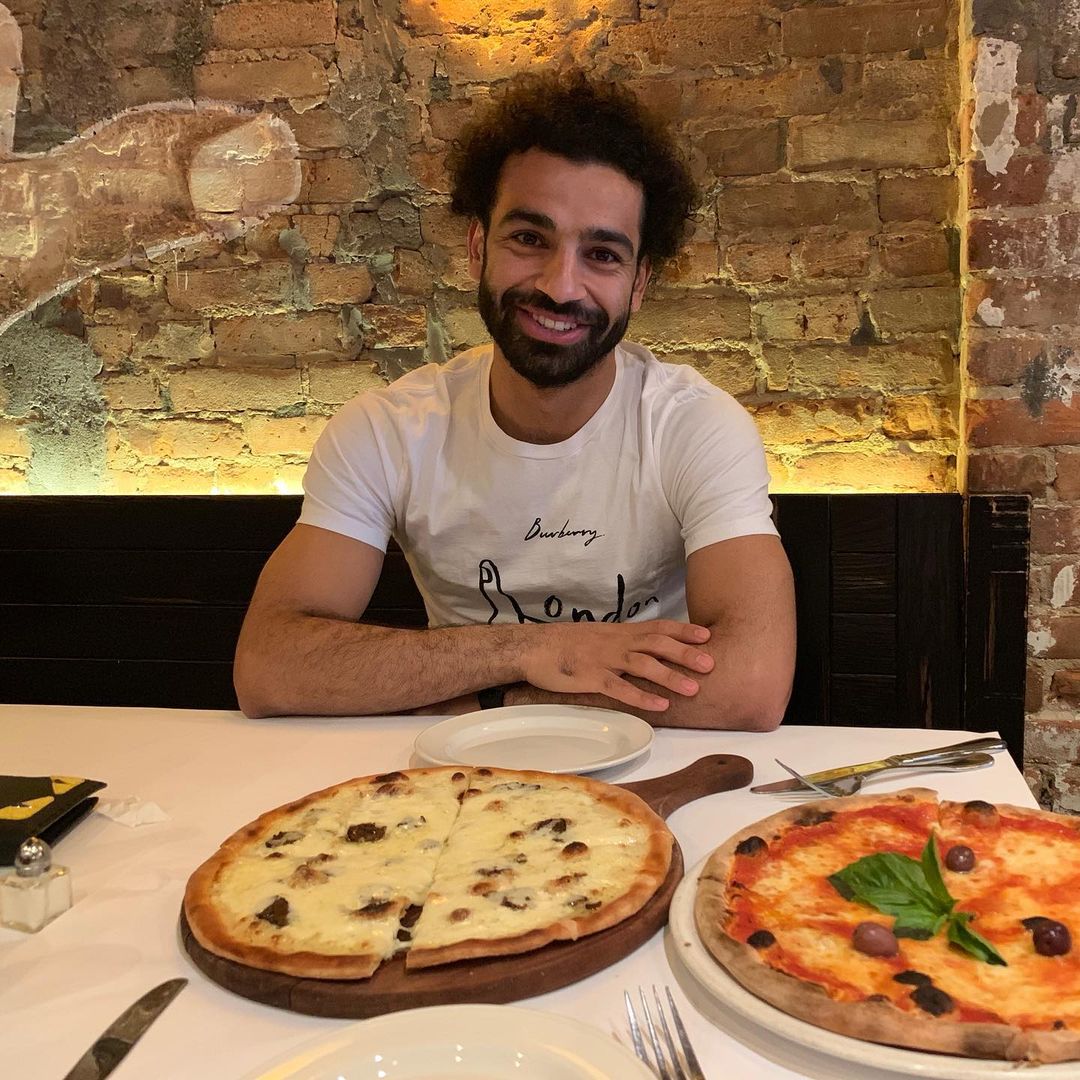 Salah about to enjoy pizza in NYC