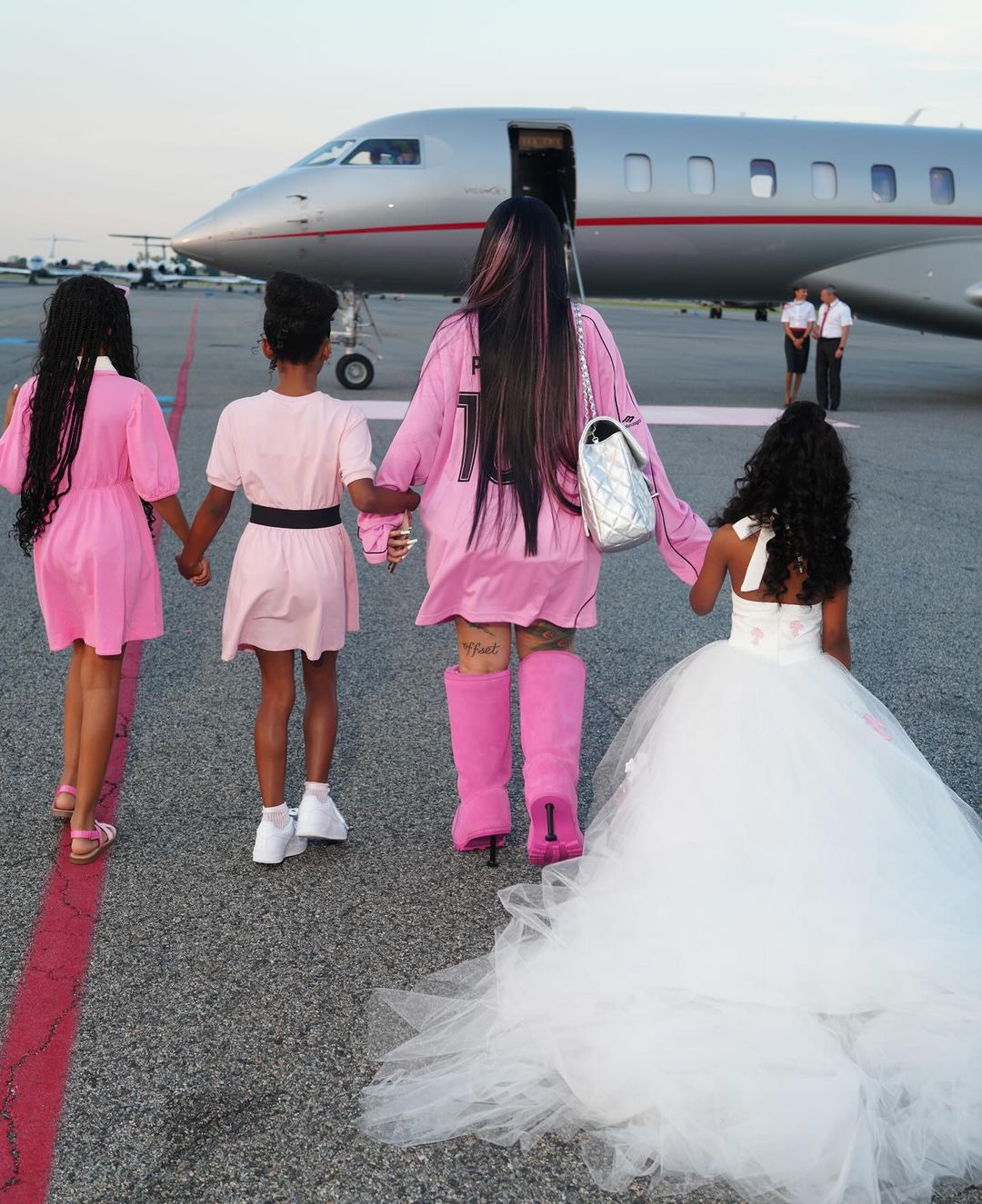 Cardi B, her daughter on the right and other children heading for  the birthday trip