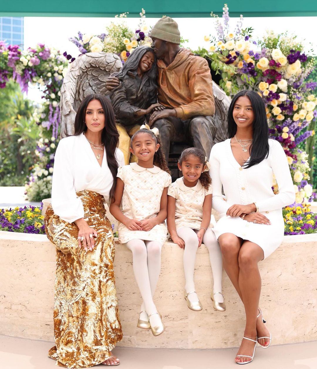 Vanessa Bryant and children and the statue of their loved ones 