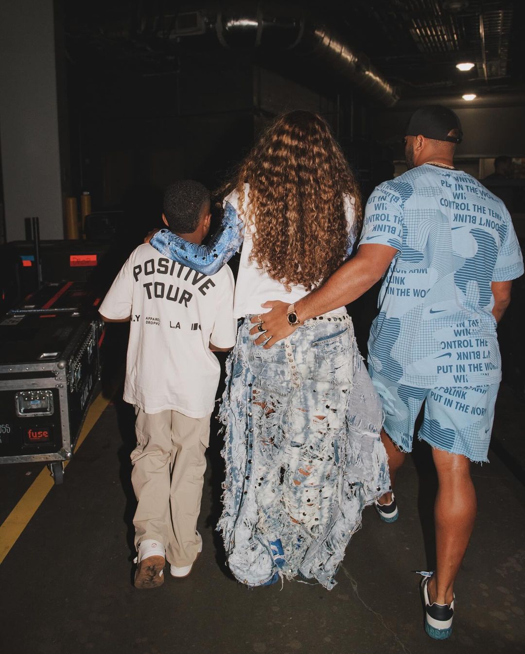 Ciara, husband and their child at a tour