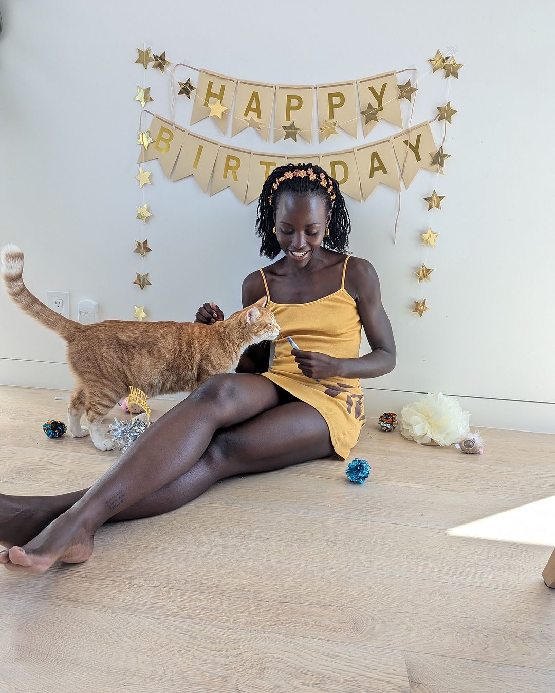 Lupita Nyong'o with her cat Yoyo celebrating 3rd birthday