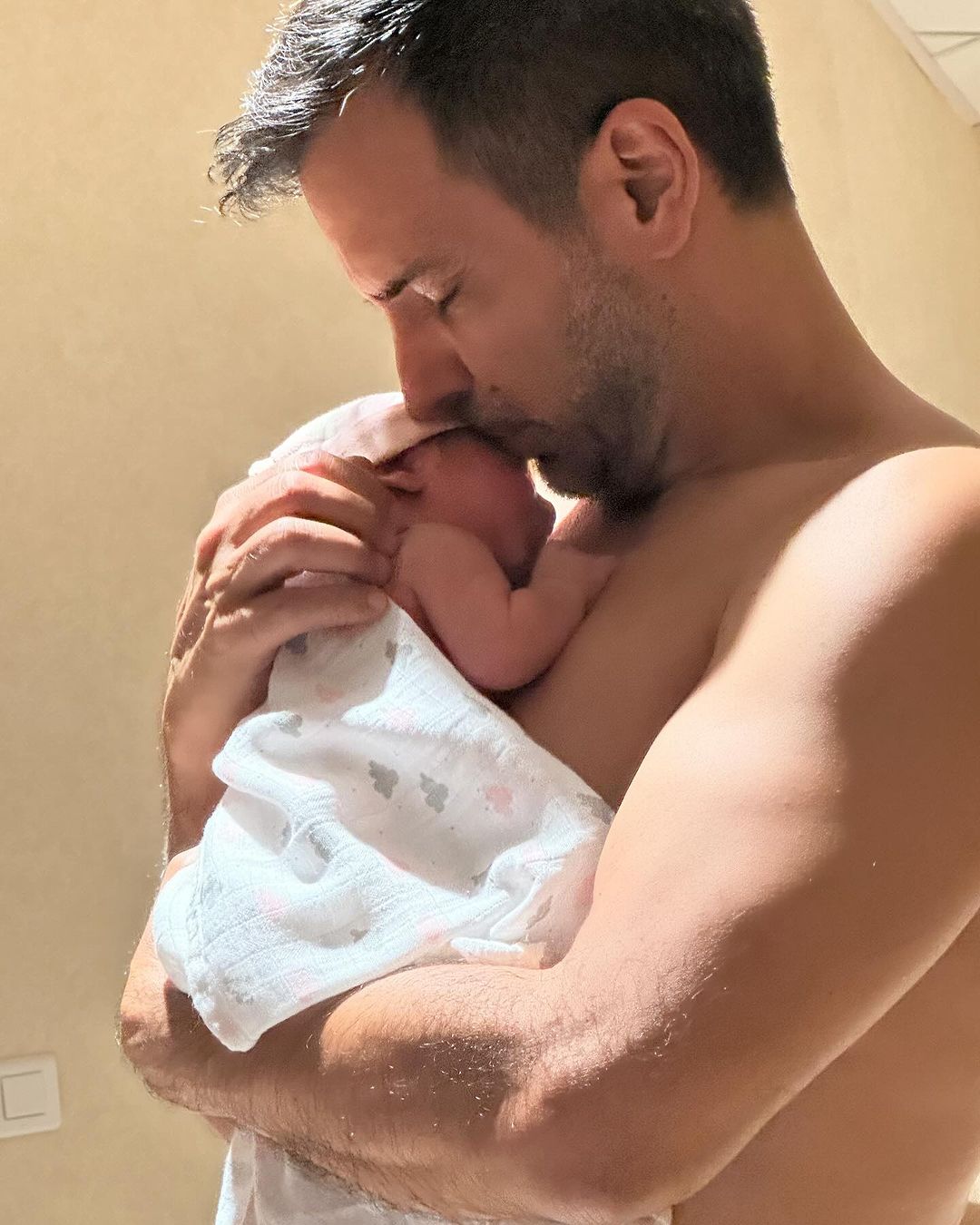 Ana Lucía's husband Jorge Cardenas holding their new born baby