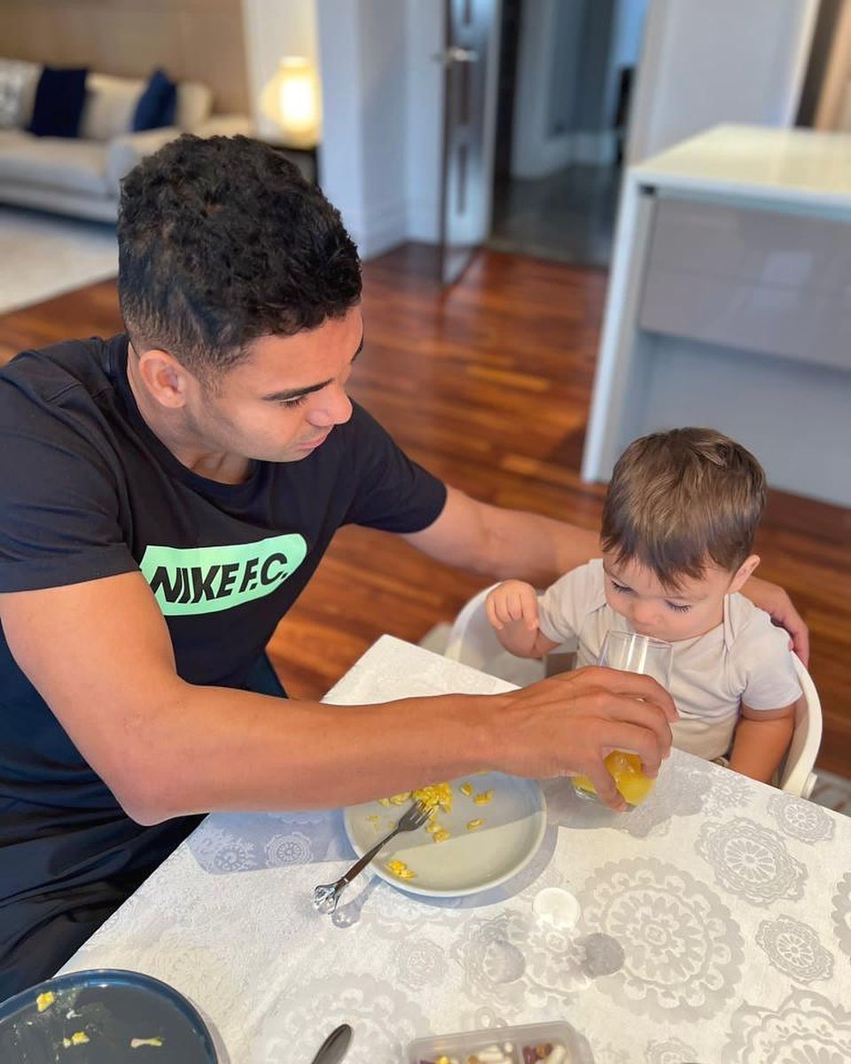 Casemiro feeding his then, baby son Caio 